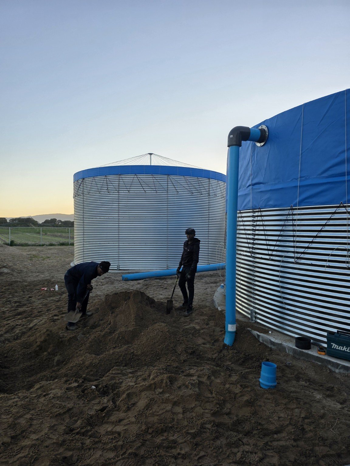 Large blue irrigation pipeline in trench