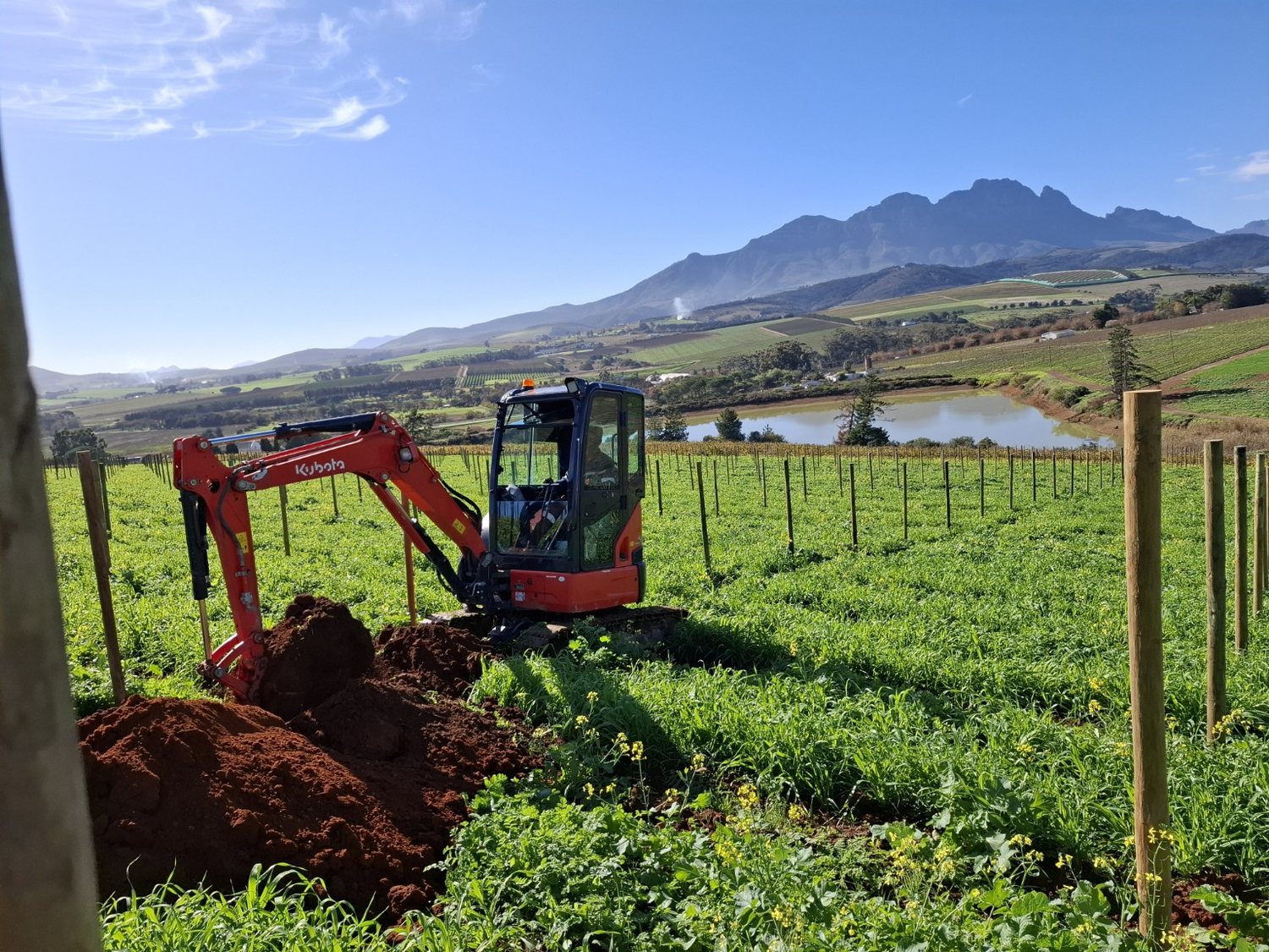 Excavator working in agricultural land